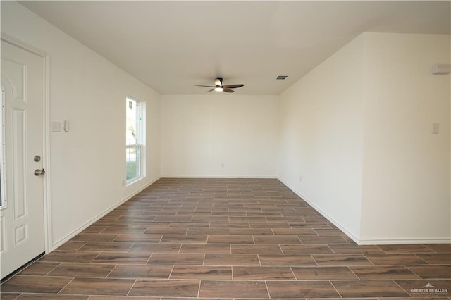 spare room featuring dark hardwood / wood-style floors and ceiling fan