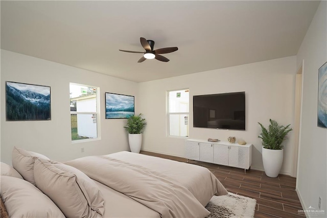 bedroom with ceiling fan and dark wood-type flooring