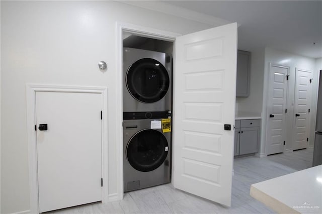 laundry room with stacked washer and dryer