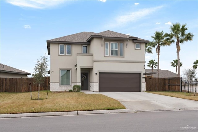 view of front property featuring a garage and a front yard