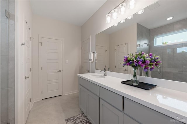 bathroom with vanity and a shower with door