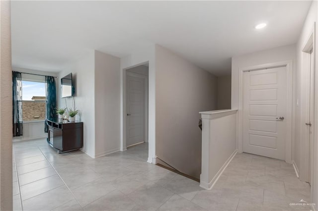 hall featuring light tile patterned flooring