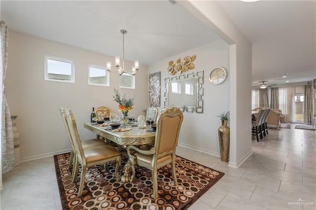 tiled dining space with an inviting chandelier and plenty of natural light