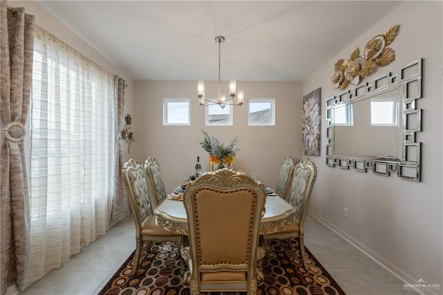 dining room featuring tile patterned floors and a chandelier