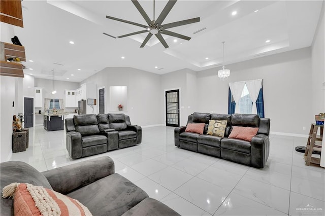 living room with ceiling fan with notable chandelier