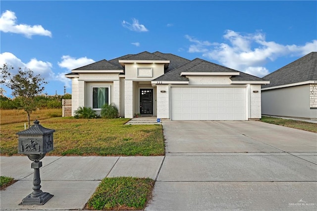 view of front facade with a garage and a front lawn