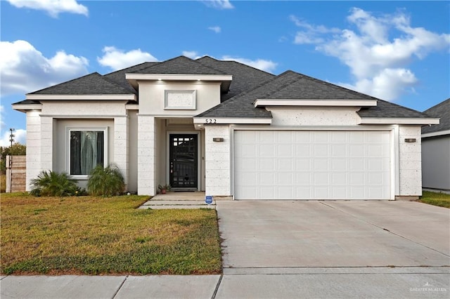 view of front of home featuring a garage and a front lawn