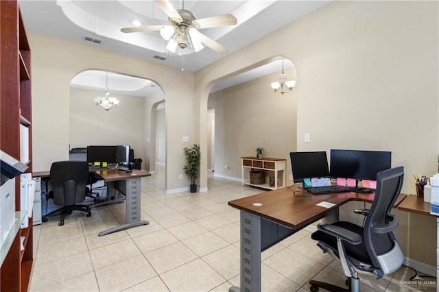 office with ceiling fan with notable chandelier, a raised ceiling, and light tile patterned floors