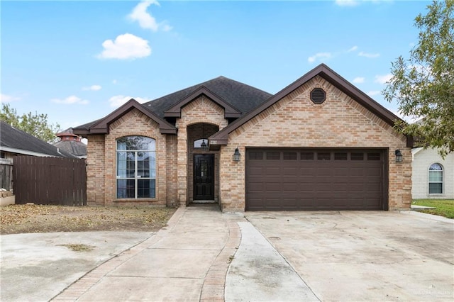 french country style house featuring a garage