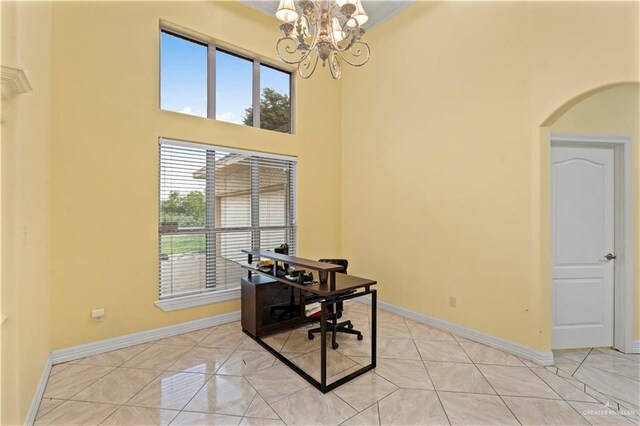 1800 E 24th St, Mission, TX 78574 - home office with an inviting chandelier, baseboards, a high ceiling, arched walkways, and light tile patterned floors