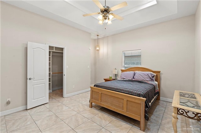 1800 E 24th St, Mission, TX 78574 - bedroom featuring baseboards, a spacious closet, ceiling fan, and a raised ceiling