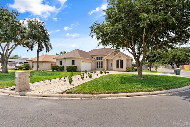 1800 E 24th St, Mission, TX 78574 - view of front of house with an attached garage, driveway, and a front yard