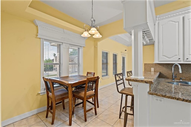 1800 E 24th St, Mission, TX 78574 - dining space with arched walkways, a tray ceiling, decorative columns, and light tile patterned floors