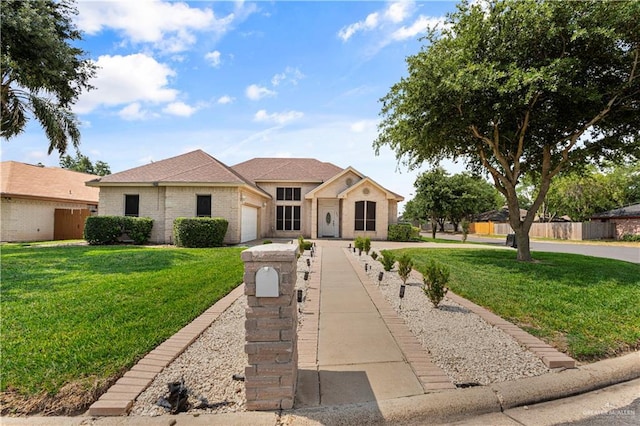 1800 E 24th St, Mission, TX 78574 - view of front of home with a garage, fence, driveway, and a front yard