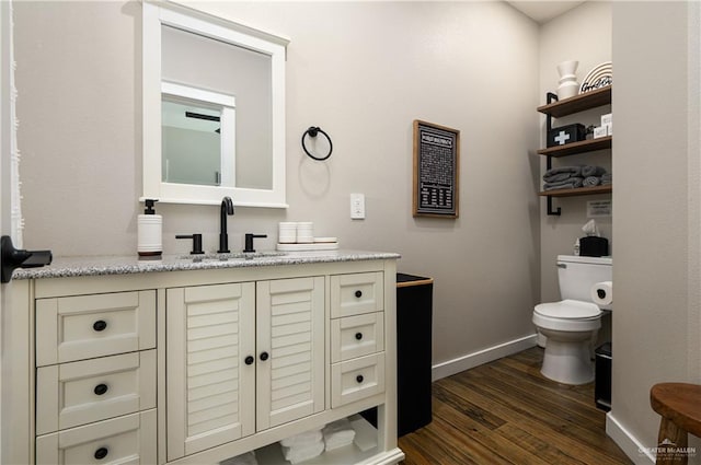 1053 Johnson Rd, Santa Fe, TX 77617 - half bath with wood finished floors, vanity, toilet, and baseboards