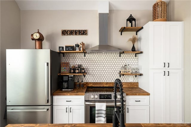 1053 Johnson Rd, Santa Fe, TX 77617 - kitchen featuring open shelves, appliances with stainless steel finishes, exhaust hood, and butcher block countertops