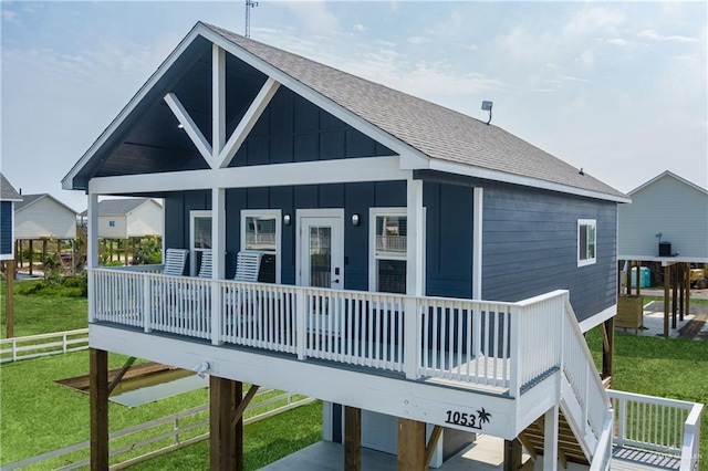 1053 Johnson Rd, Santa Fe, TX 77617 - back of property featuring a shingled roof, board and batten siding, and a porch