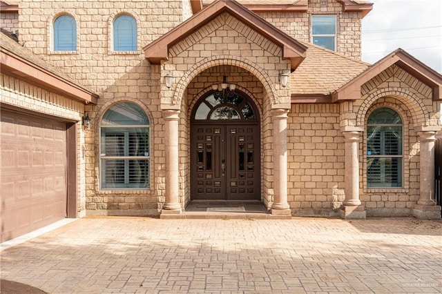 view of exterior entry with a garage