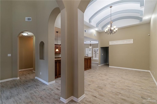 interior space featuring light hardwood / wood-style flooring and a chandelier