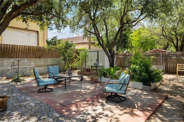 2403 Silver Oak Ave, Mission, TX 78574 - view of patio / terrace featuring a fenced backyard, an outdoor structure, and a storage unit