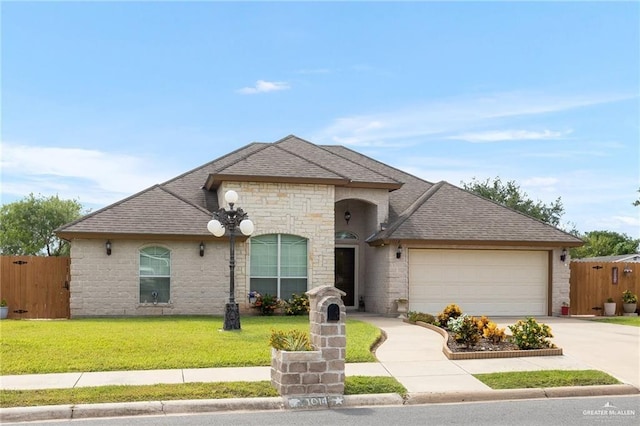 view of front of house featuring a garage and a front lawn