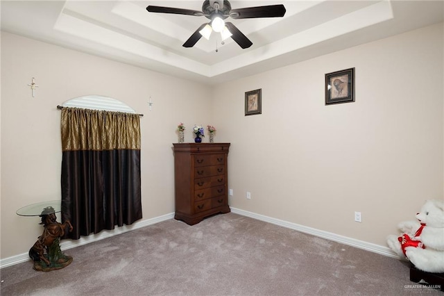 interior space featuring a tray ceiling and ceiling fan