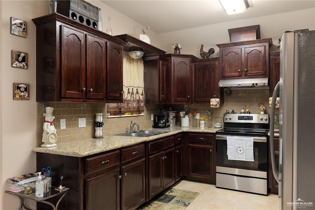 kitchen with light tile patterned floors, stainless steel appliances, tasteful backsplash, and sink