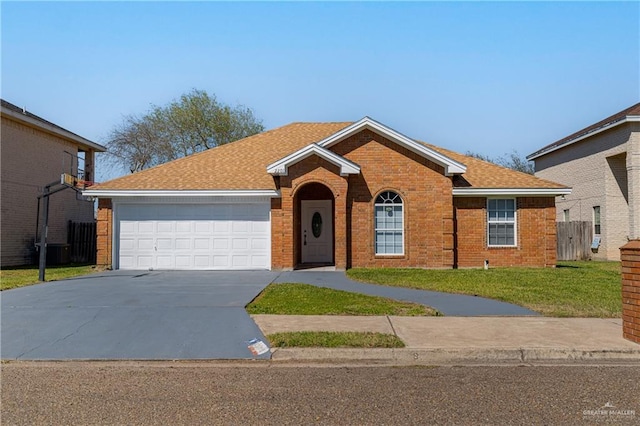 single story home with brick siding, concrete driveway, fence, a garage, and a front lawn