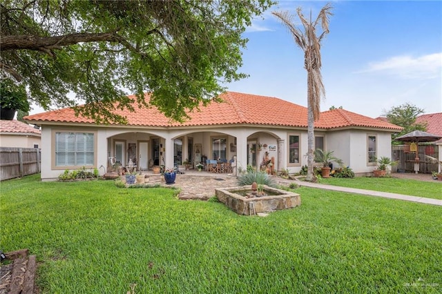 back of house with a yard and a patio