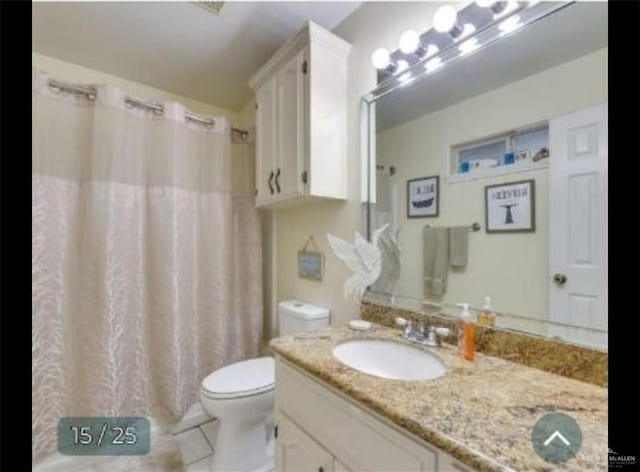 full bathroom featuring toilet, vanity, and tile patterned floors