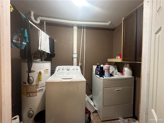 washroom featuring water heater, cabinets, a textured ceiling, and independent washer and dryer