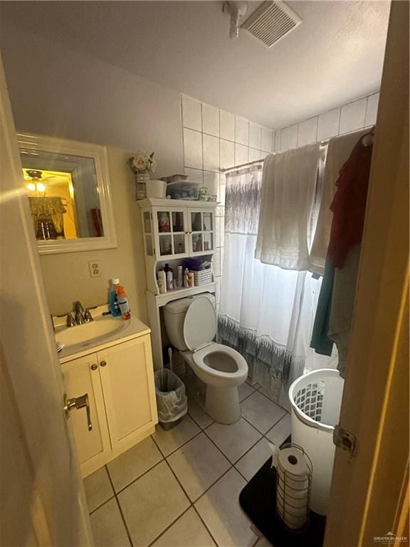 bathroom featuring tile patterned flooring, vanity, and toilet