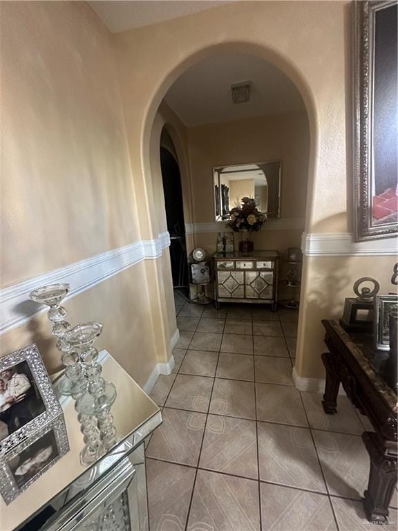 hall featuring light tile patterned flooring