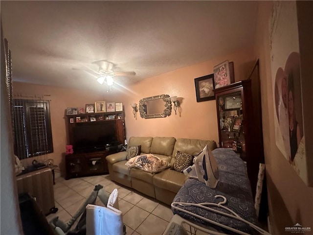 living room featuring ceiling fan and light tile patterned flooring