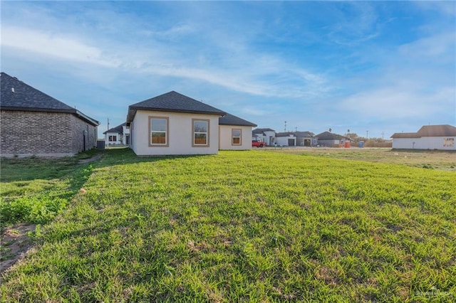 back of house with a lawn