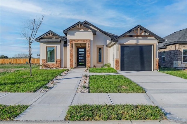 view of front facade with driveway, an attached garage, fence, a front lawn, and stucco siding