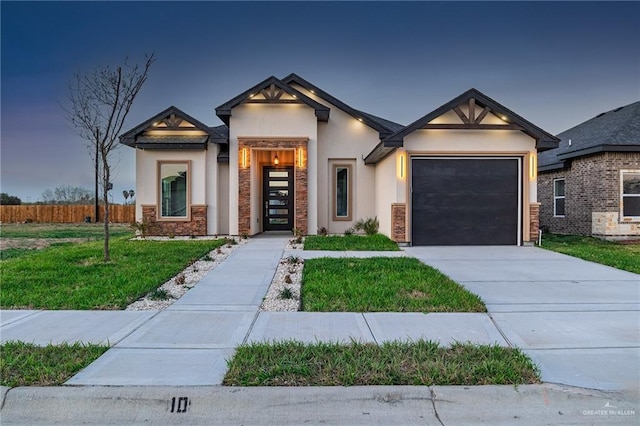 view of front facade featuring a garage, driveway, stucco siding, fence, and a front yard