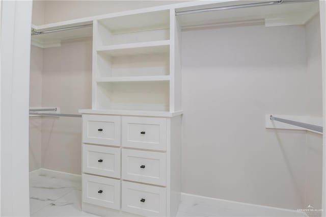 spacious closet with marble finish floor