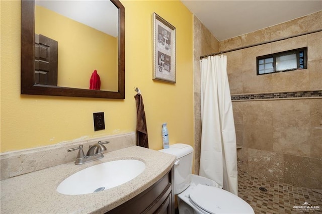 bathroom with vanity, toilet, and walk in shower