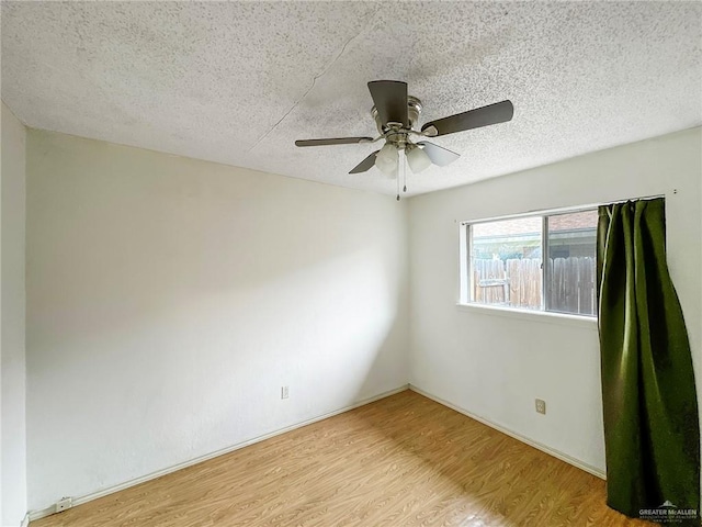 2417 W Iris Ave, Mcallen, TX 78501 - unfurnished room with a textured ceiling, wood finished floors, and ceiling fan