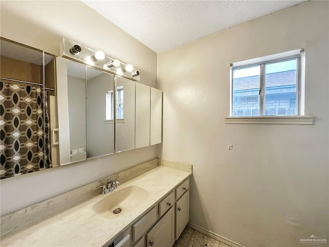 2417 W Iris Ave, Mcallen, TX 78501 - full bathroom featuring vanity, a textured ceiling, and baseboards