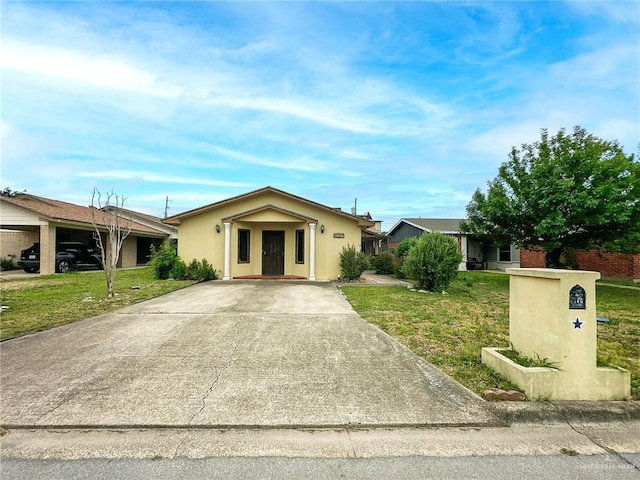 2417 W Iris Ave, Mcallen, TX 78501 - ranch-style home with a front lawn, driveway, and stucco siding