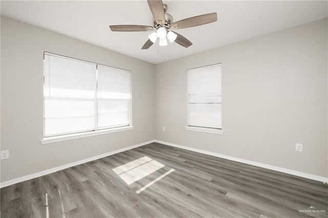 unfurnished room featuring dark wood-type flooring and ceiling fan