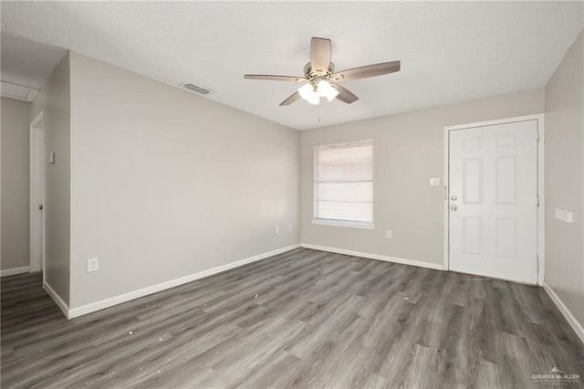 empty room with dark hardwood / wood-style floors and ceiling fan