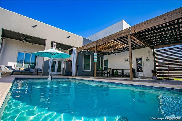 view of swimming pool featuring french doors, a patio, and ceiling fan