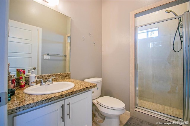 bathroom featuring walk in shower, vanity, and toilet