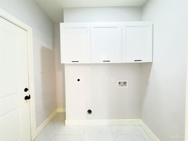 laundry room featuring electric dryer hookup, hookup for a washing machine, and cabinets