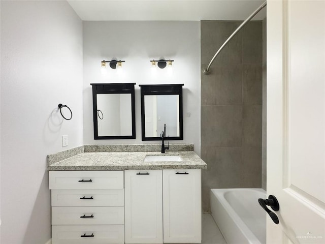 bathroom featuring vanity and tiled shower / bath combo