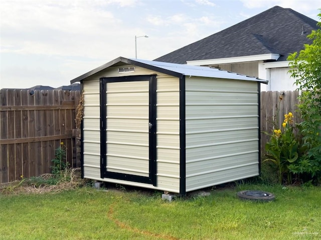 view of outbuilding with a yard