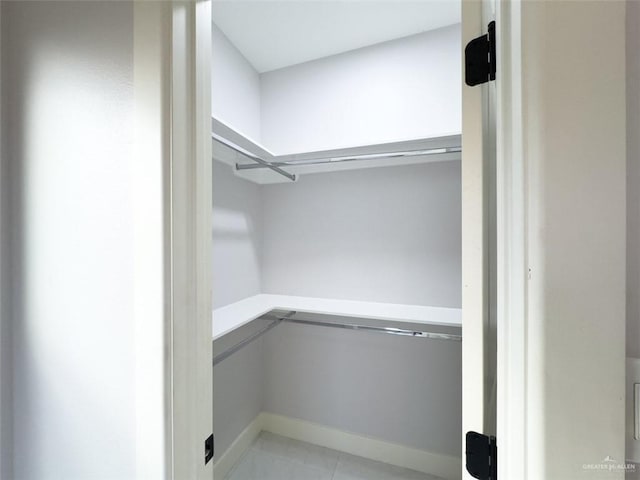 spacious closet featuring light tile patterned floors